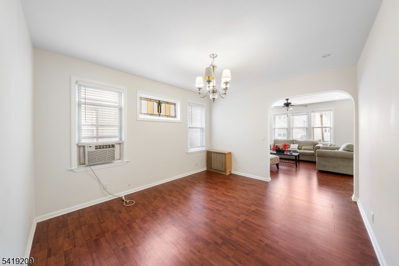 752 Eaton Street Elizabeth, NJ 07202 - Photo 10 of 27 a living room with furniture and a chandelier