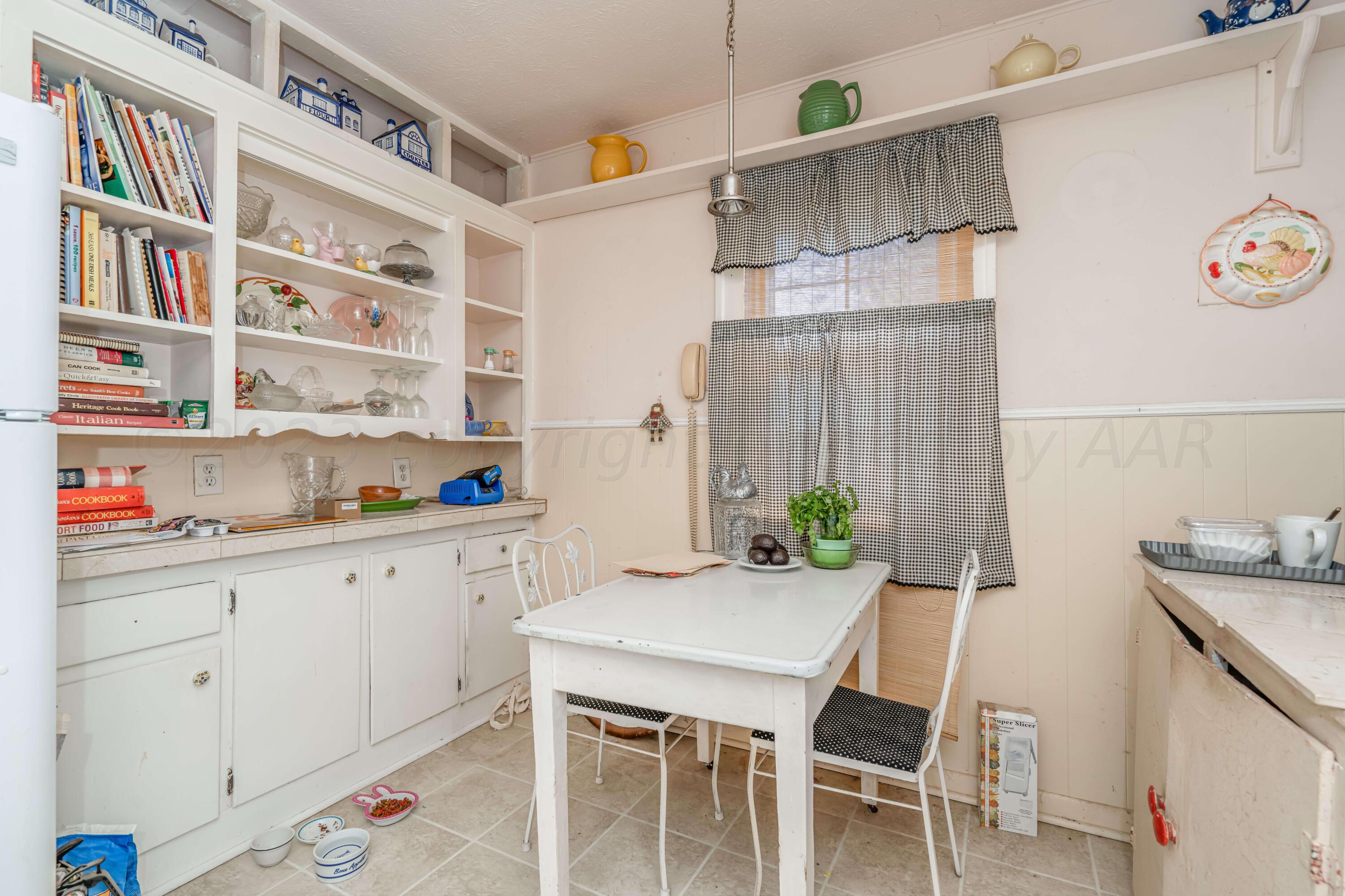 4809 Arden Road Amarillo, TX 79110 - Photo 16 of 34 a kitchen with a table and chairs in it