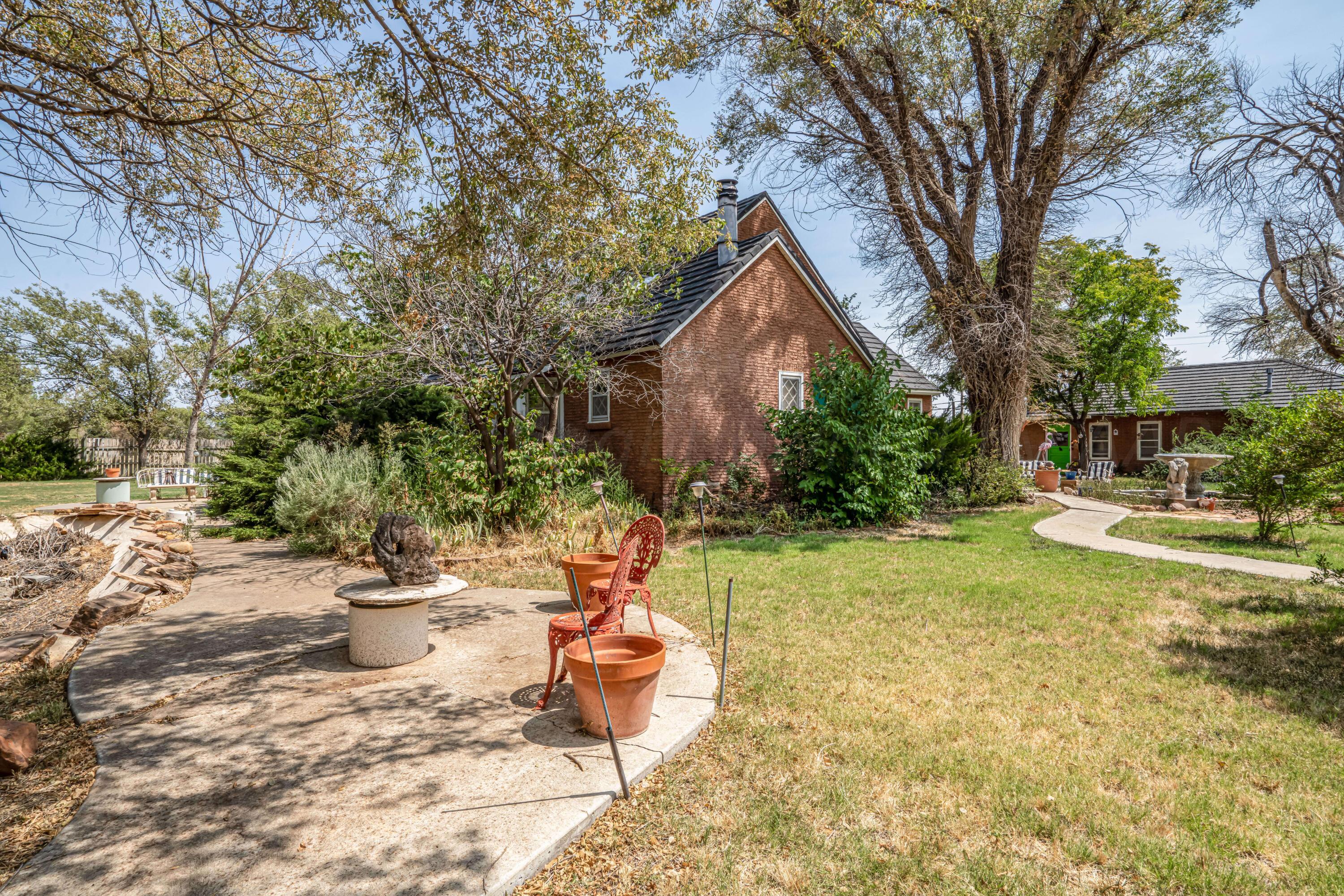 4809 Arden Road Amarillo, TX 79110 - Photo 2 of 34 a view of a backyard with table and chairs and potted plants