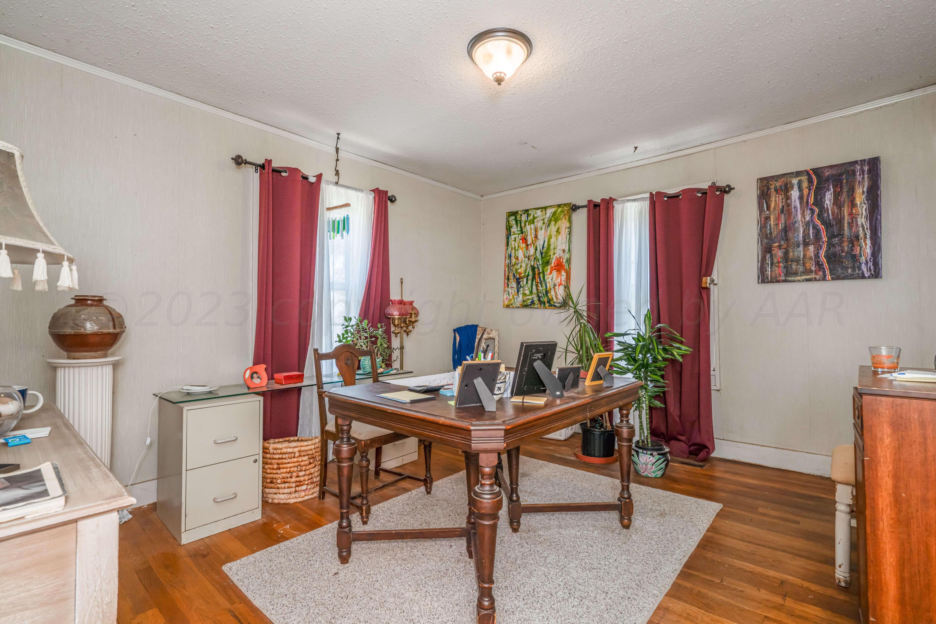 4809 Arden Road Amarillo, TX 79110 - Photo 21 of 34 a view of a workspace with furniture and a window