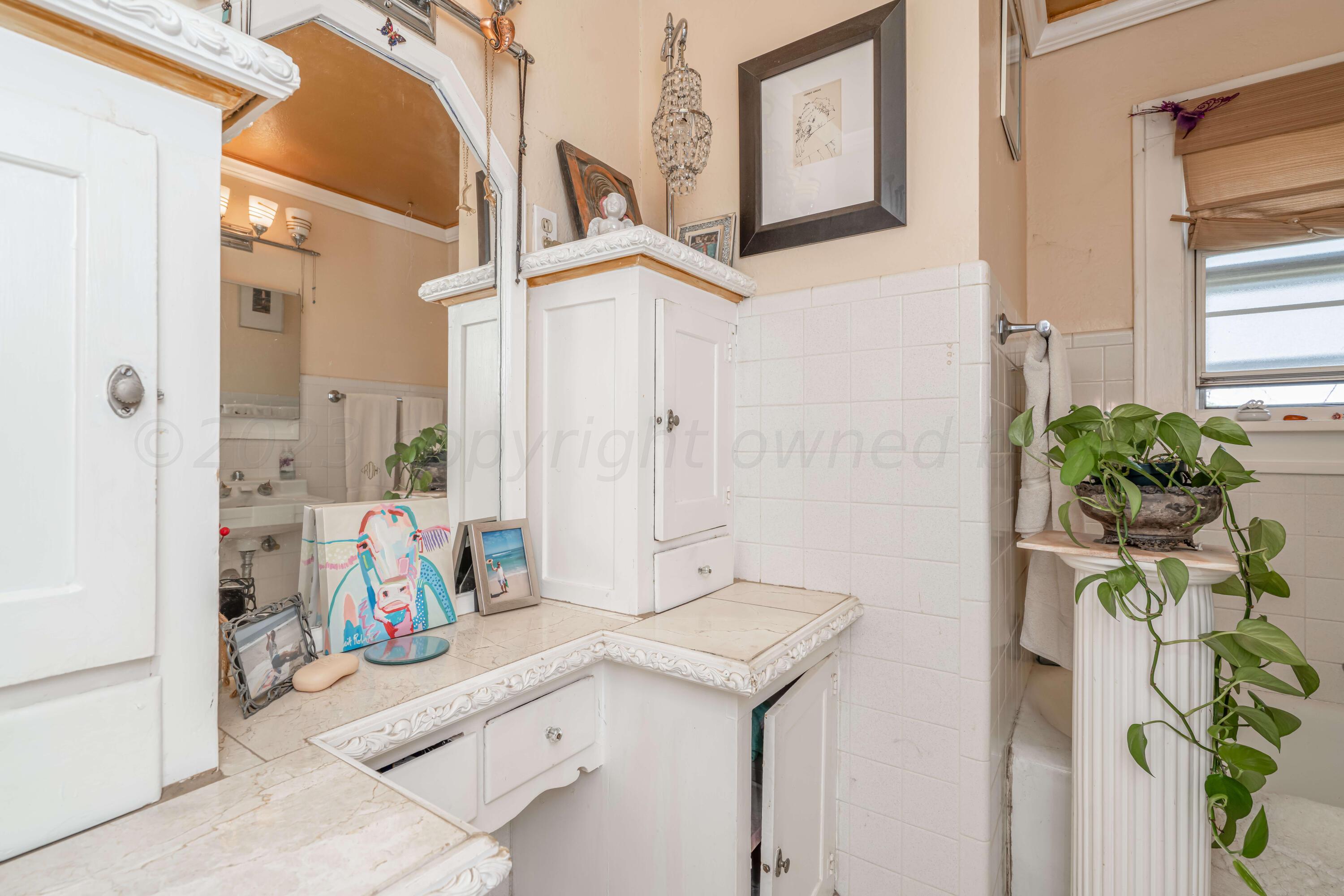 4809 Arden Road Amarillo, TX 79110 - Photo 23 of 34 a bathroom with a sink and a mirror