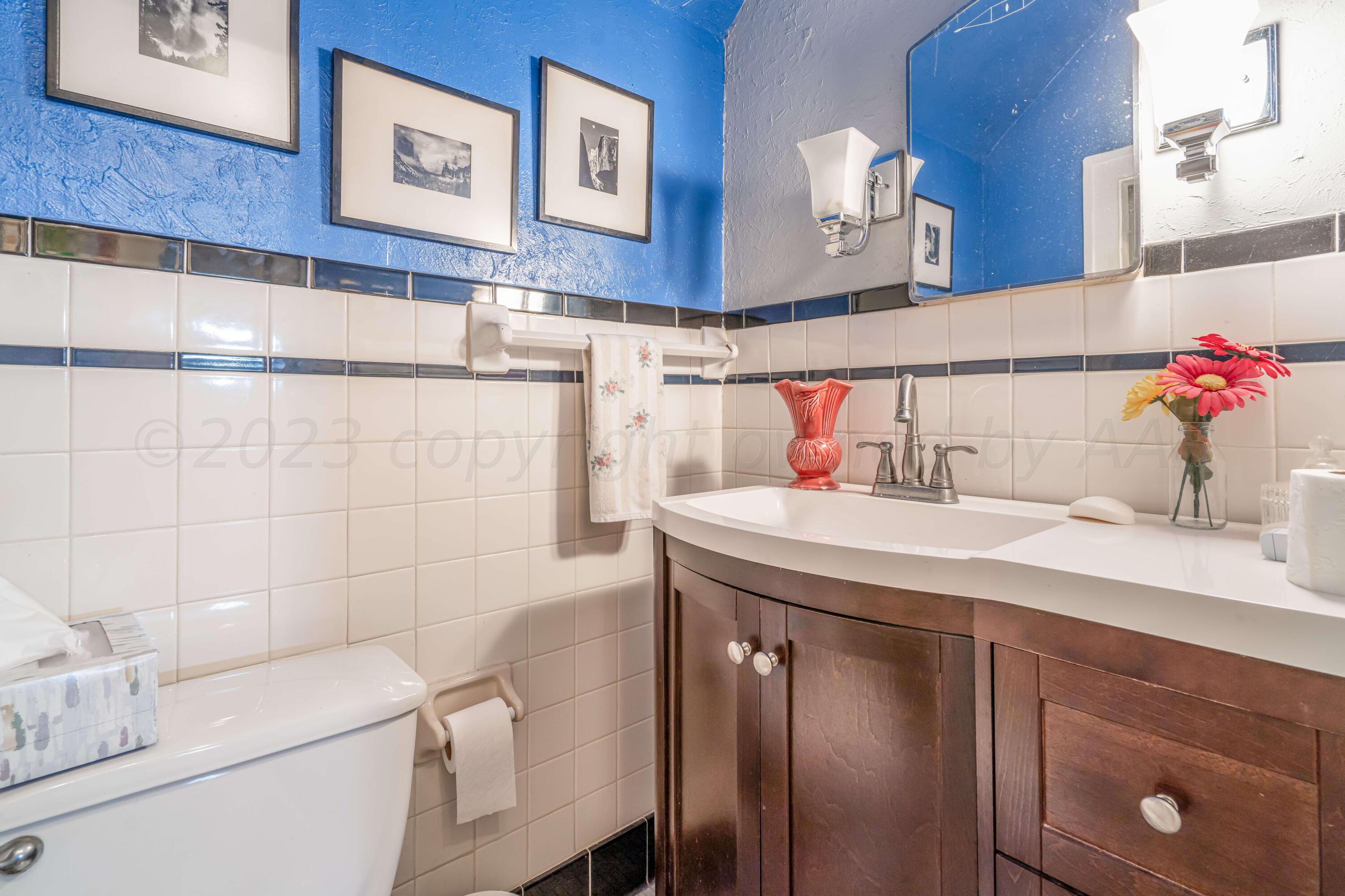 4809 Arden Road Amarillo, TX 79110 - Photo 27 of 34 a bathroom with a sink and a mirror