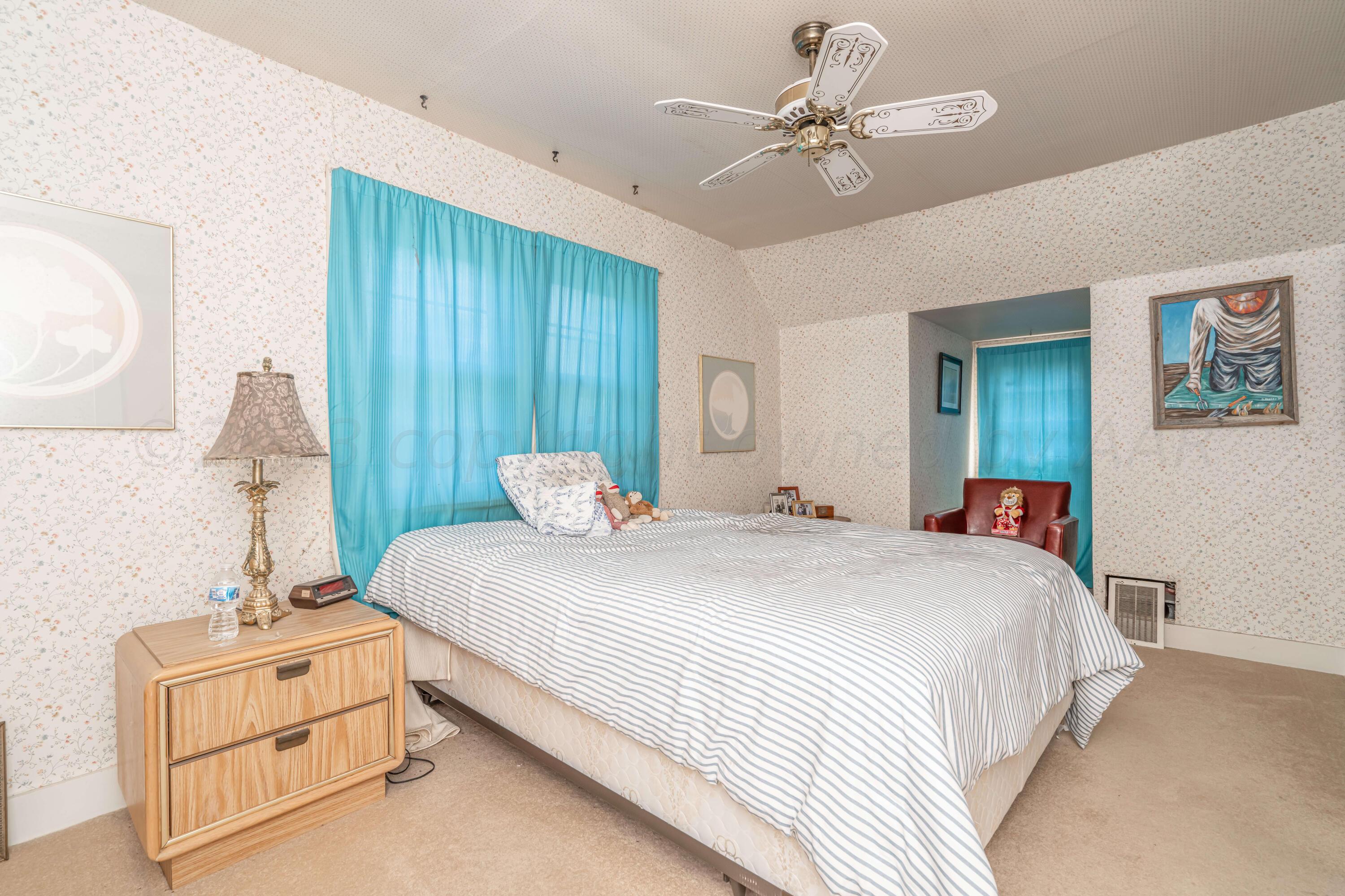 4809 Arden Road Amarillo, TX 79110 - Photo 28 of 34 a bedroom with a bed and a chandelier