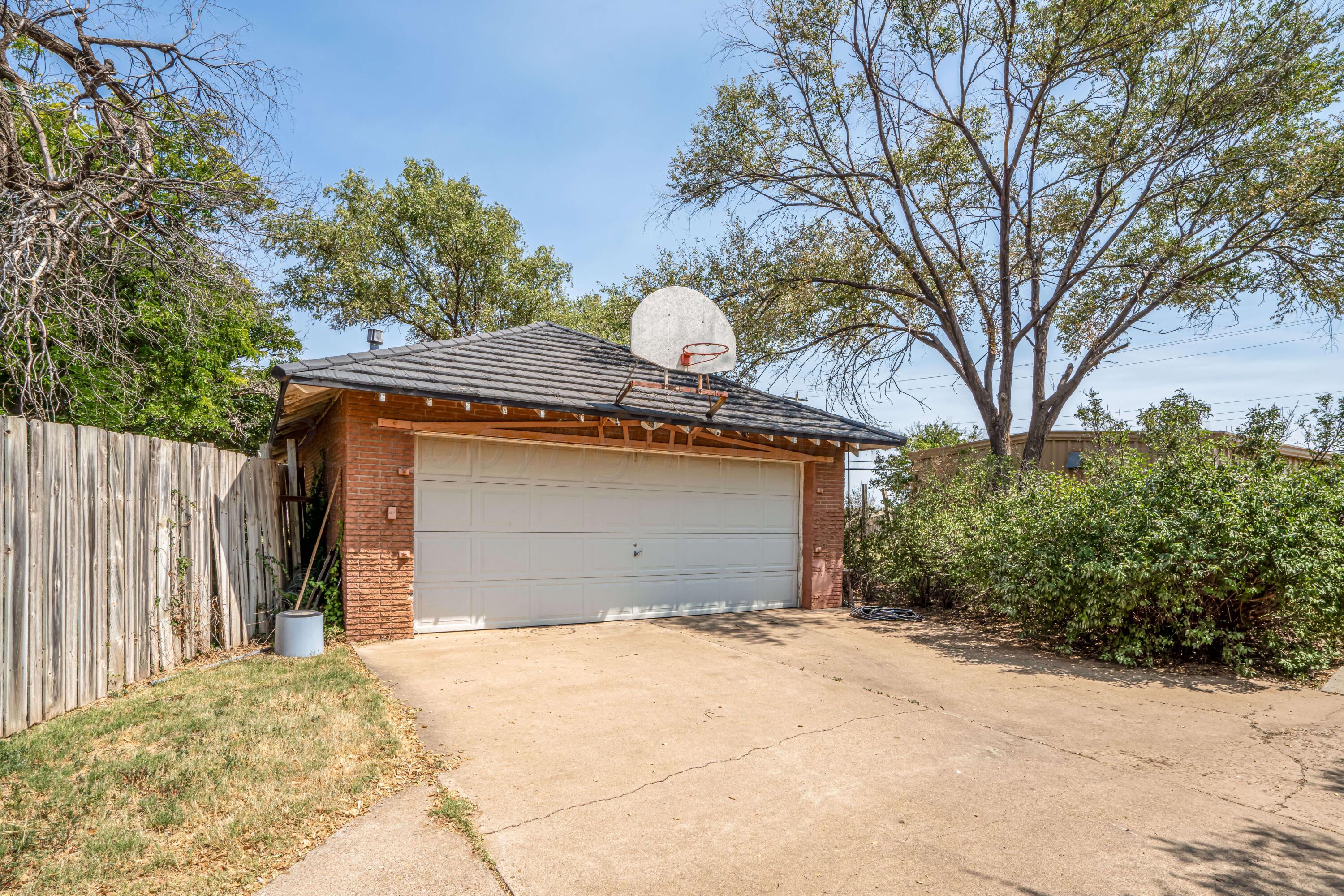 4809 Arden Road Amarillo, TX 79110 - Photo 32 of 34 a front view of a house with a yard and garage