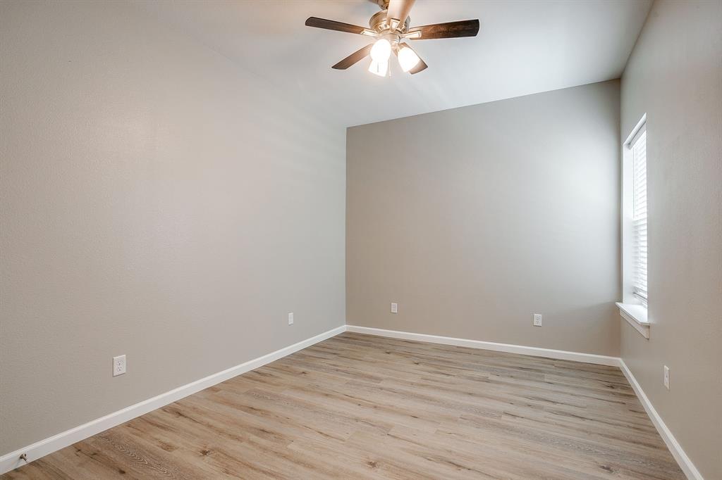 133 Winners Circle, Unit 102 Weatherford, TX 76087 - Photo 14 of 20 Spare room with a ceiling fan and light wood finished floors