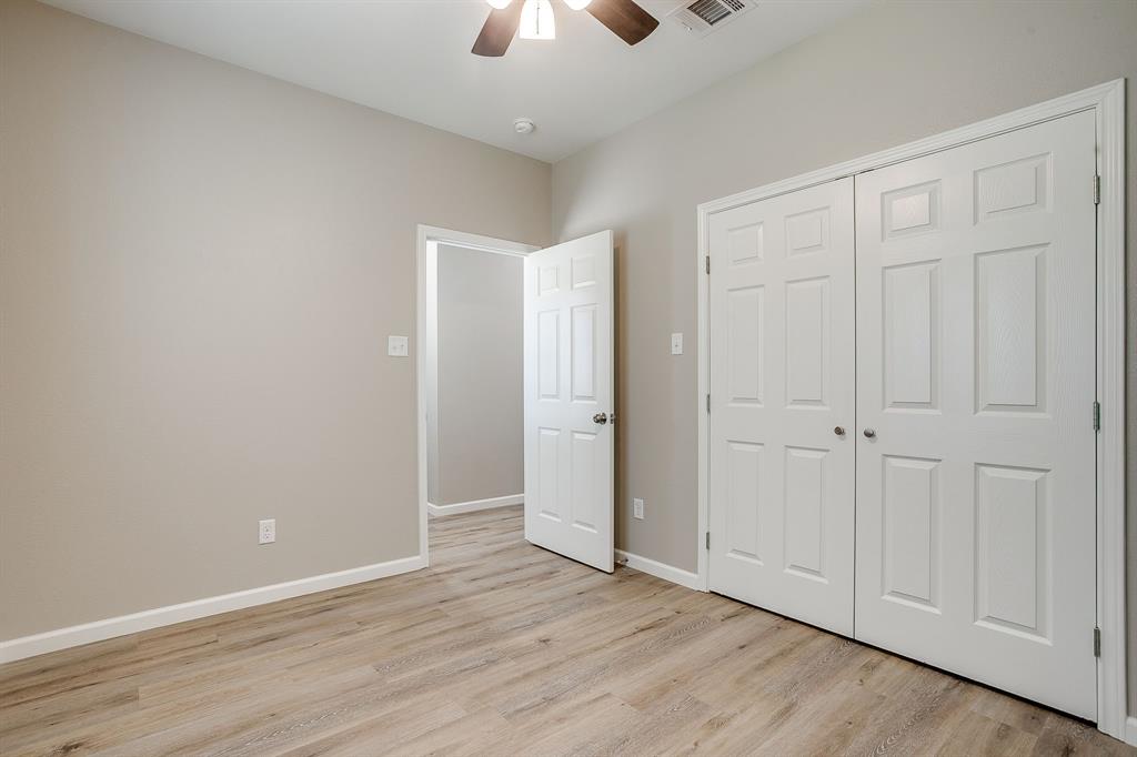 133 Winners Circle, Unit 102 Weatherford, TX 76087 - Photo 17 of 20 Unfurnished bedroom featuring light wood finished floors, a closet, and ceiling fan