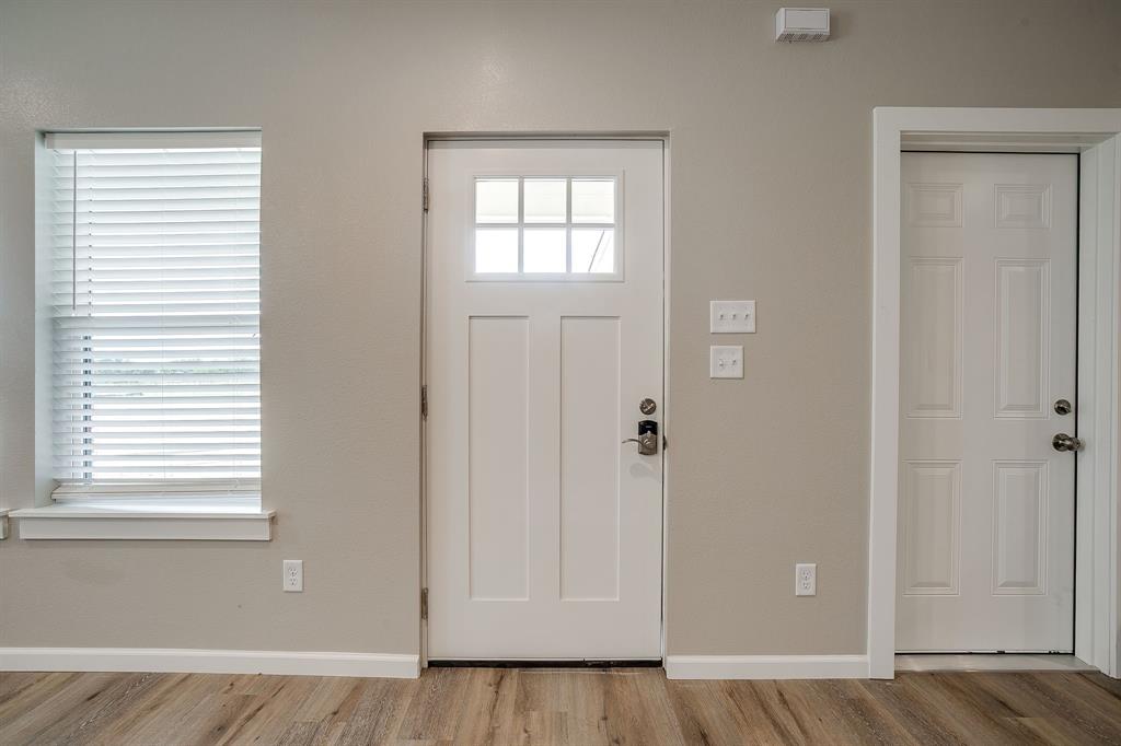 133 Winners Circle, Unit 102 Weatherford, TX 76087 - Photo 5 of 20 Entryway with wood finished floors and baseboards
