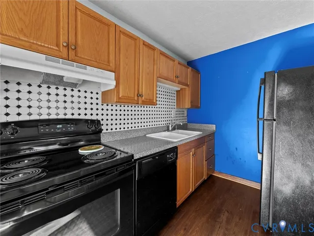 a kitchen that has a sink and a stove