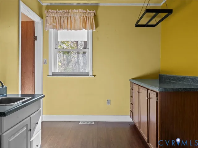 a view of utility room with closet and wooden floor