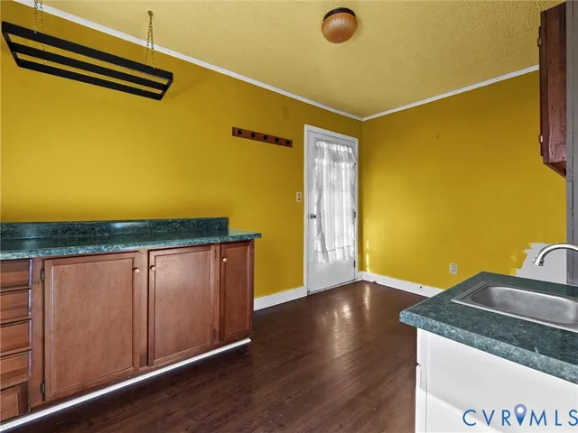 a view of a room with wooden floor and windows
