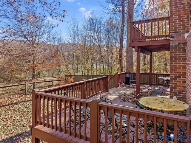 a view of a roof deck with wooden fence and floor