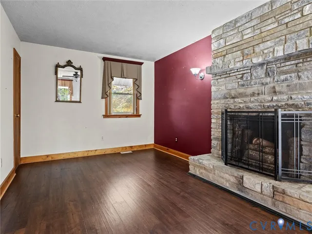 a view of a hallway with wooden floor and a fireplace