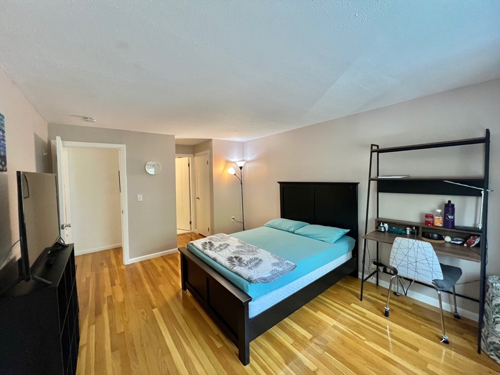 95 Maple Street, Unit 18 Malden, MA 02148 - Photo 12 of 24 a bedroom with a bed and glass table