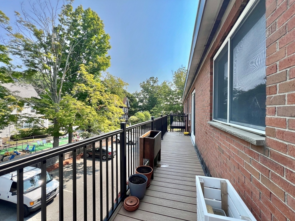 95 Maple Street, Unit 18 Malden, MA 02148 - Photo 21 of 24 a view of balcony with wooden floor and fence
