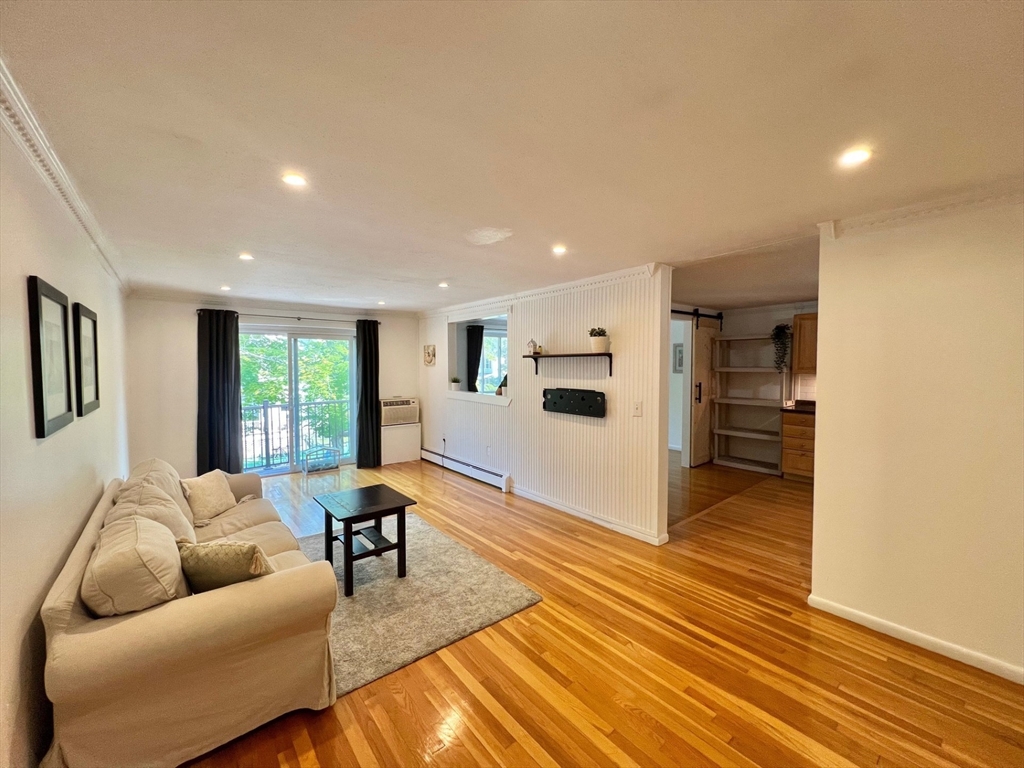 95 Maple Street, Unit 18 Malden, MA 02148 - Photo 6 of 24 a living room with furniture and a table