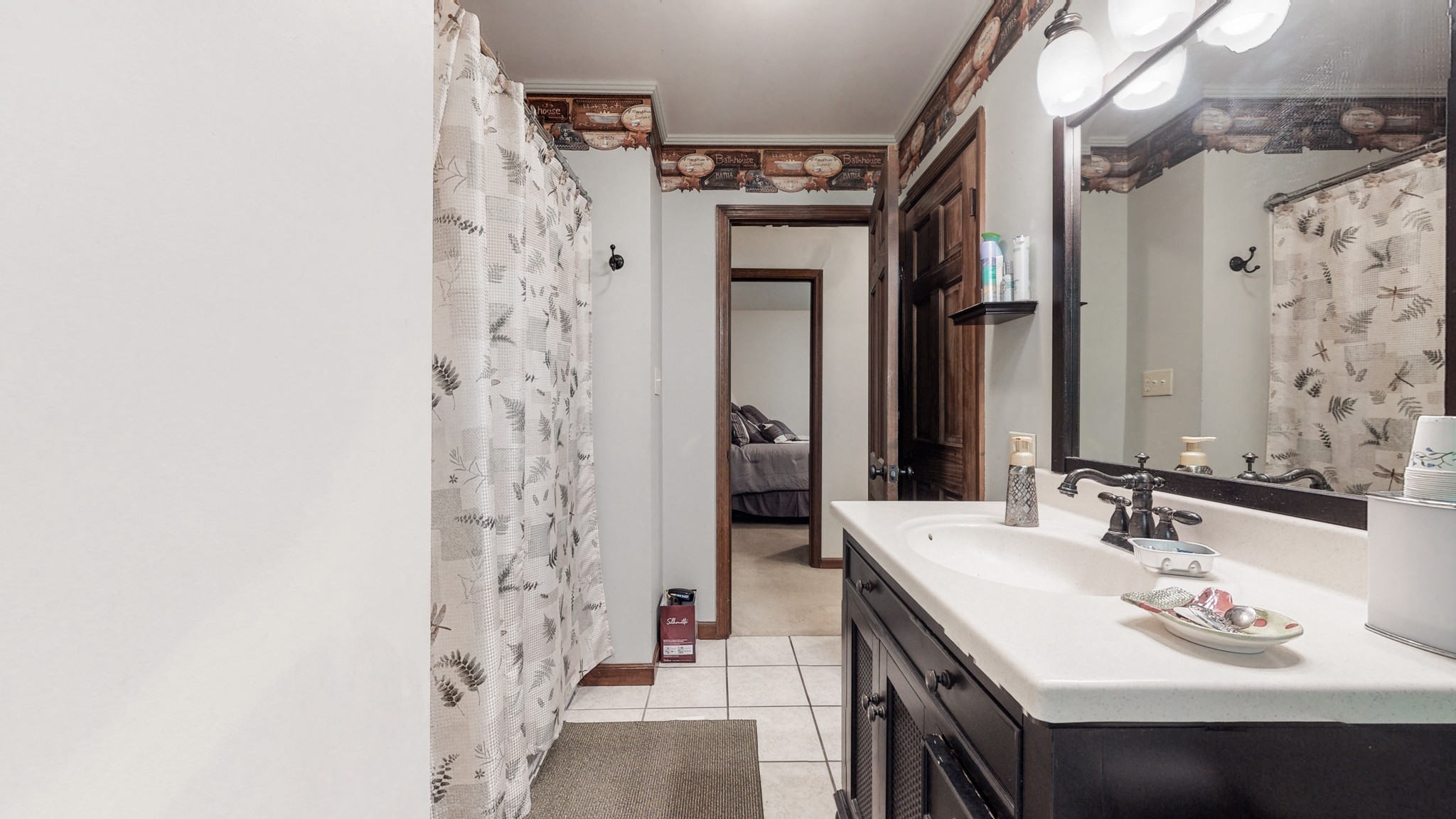 7707 Murfreesboro Road Lebanon, TN 37090 - Photo 24 of 45 a en suite bathroom with a sink a mirror and a shower
