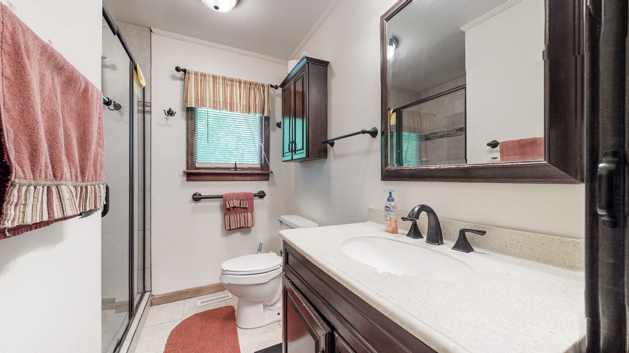 7707 Murfreesboro Road Lebanon, TN 37090 - Photo 29 of 45 a bathroom with a sink a toilet and a mirror