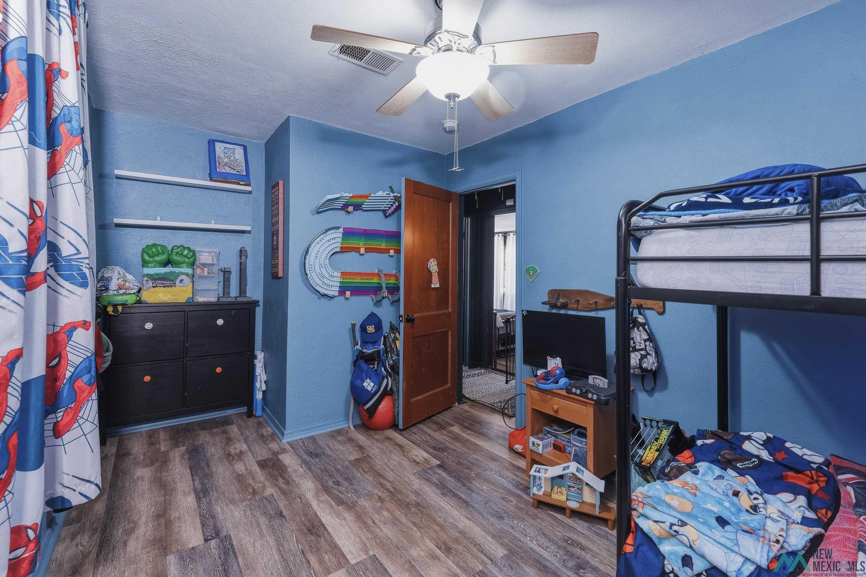 1432 South 5th Street Raton, NM 87740 - Photo 15 of 32 Bedroom featuring dark wood-type flooring and ceiling fan