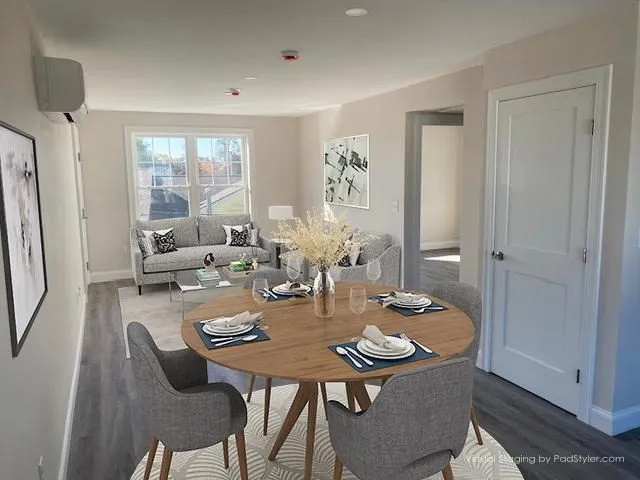 a view of a dining room with furniture and wooden floor