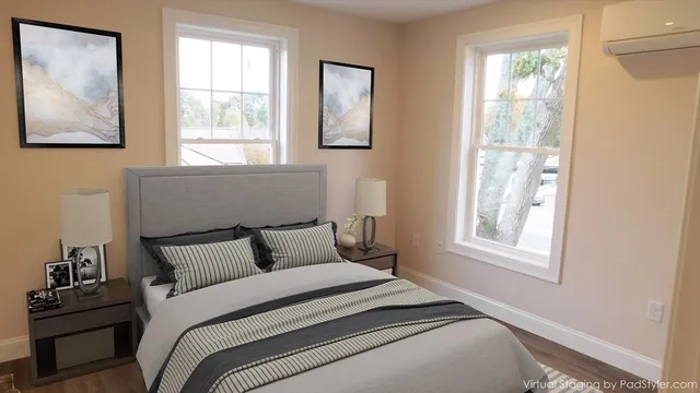 a bedroom with a bed and a window