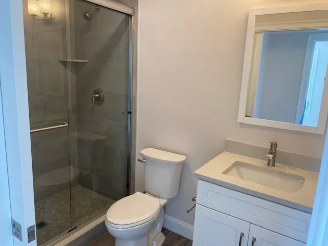 a bathroom with a sink toilet and shower