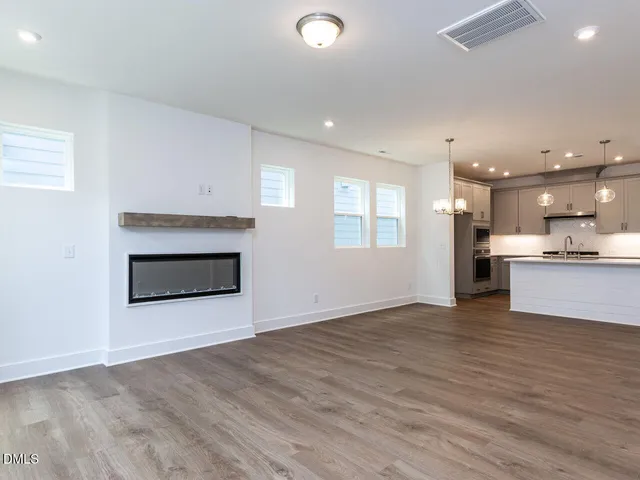 a view of a kitchen with a sink and a fireplace