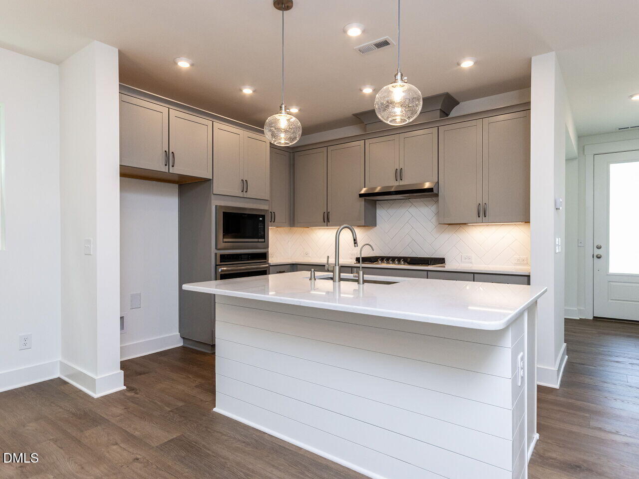 7 Tallgrass Road Pittsboro, NC 27312 - Photo 14 of 32 a kitchen with kitchen island granite countertop a stove a sink and a refrigerator
