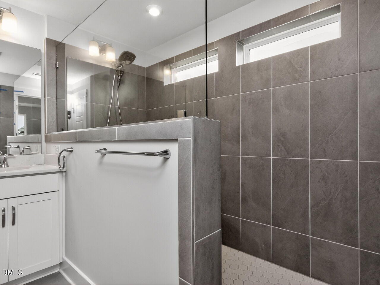 7 Tallgrass Road Pittsboro, NC 27312 - Photo 22 of 37 a bathroom with a shower a sink a toilet a mirror and a shower