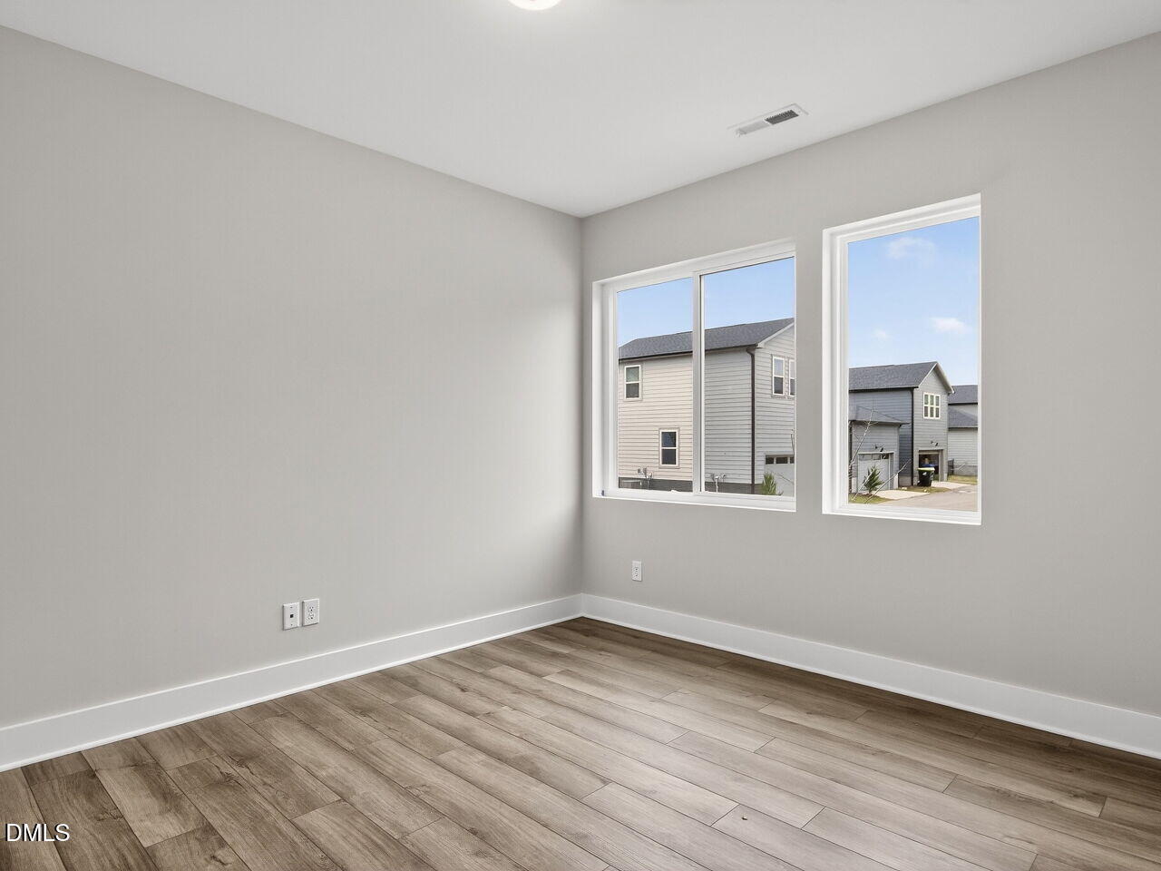 7 Tallgrass Road Pittsboro, NC 27312 - Photo 5 of 37 a view of an empty room with wooden floor and a window