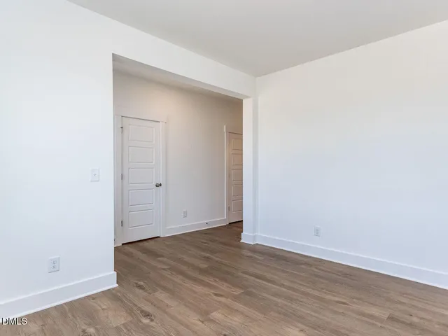 an empty room with wooden floor