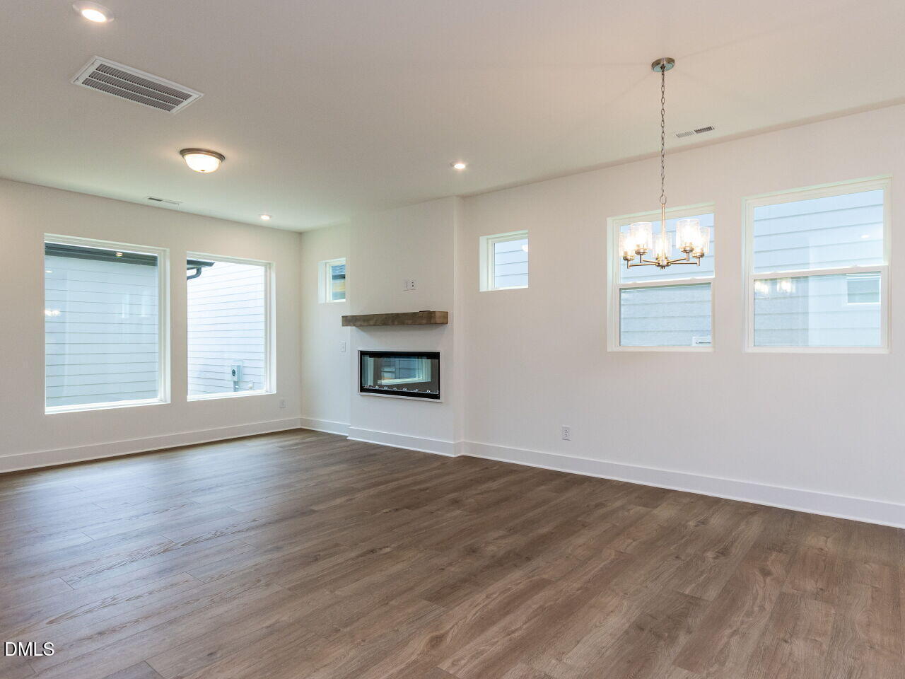 7 Tallgrass Road Pittsboro, NC 27312 - Photo 7 of 32 a view of an empty room with window and wooden floor