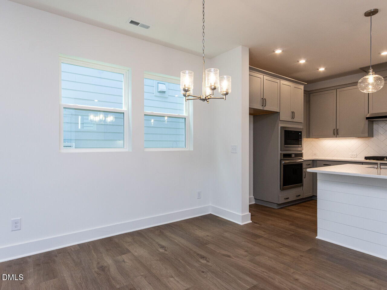 7 Tallgrass Road Pittsboro, NC 27312 - Photo 8 of 32 a view of a kitchen with a refrigerator stove cabinets and empty room