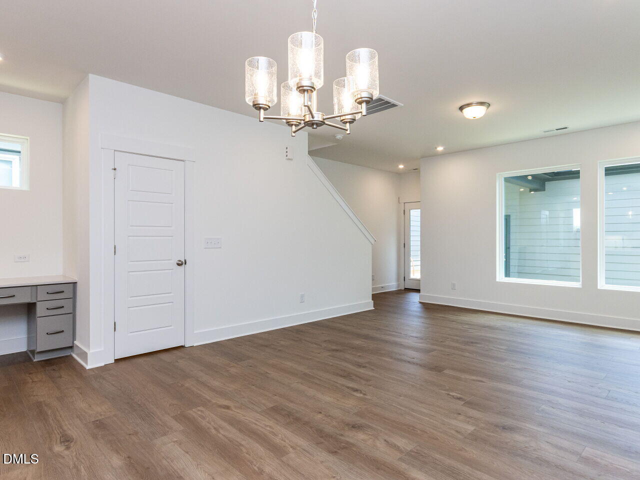 7 Tallgrass Road Pittsboro, NC 27312 - Photo 9 of 32 an empty room with wooden floor chandelier and windows