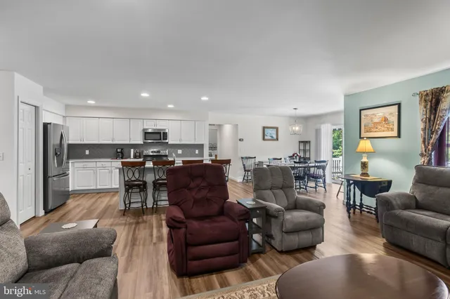 a living room kitchen with furniture and kitchen view