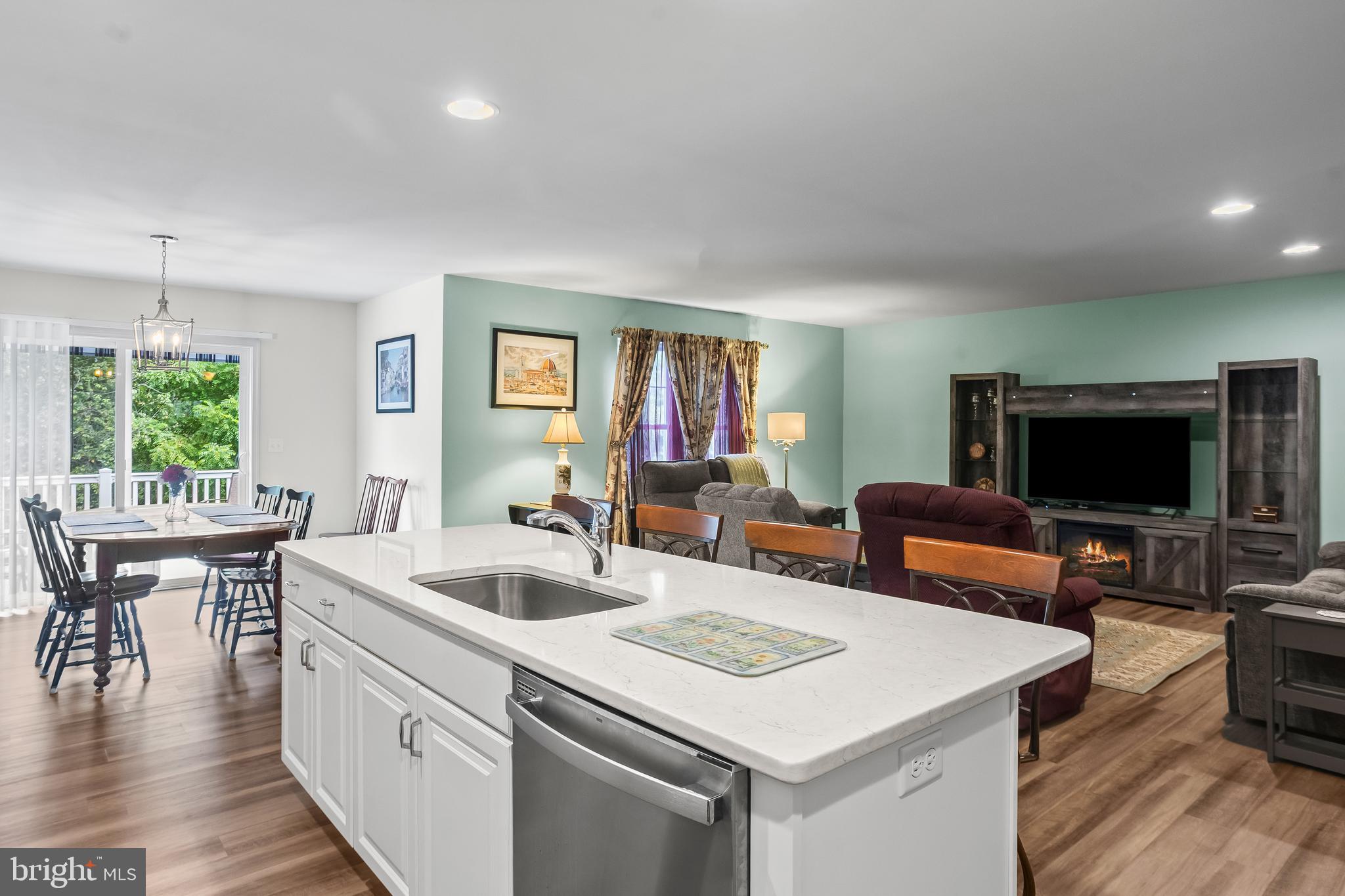 2069 Spring Wood Lane Mechanicsburg, PA 17055 - Photo 16 of 41 a view of kitchen island a sink wooden floor and a living room