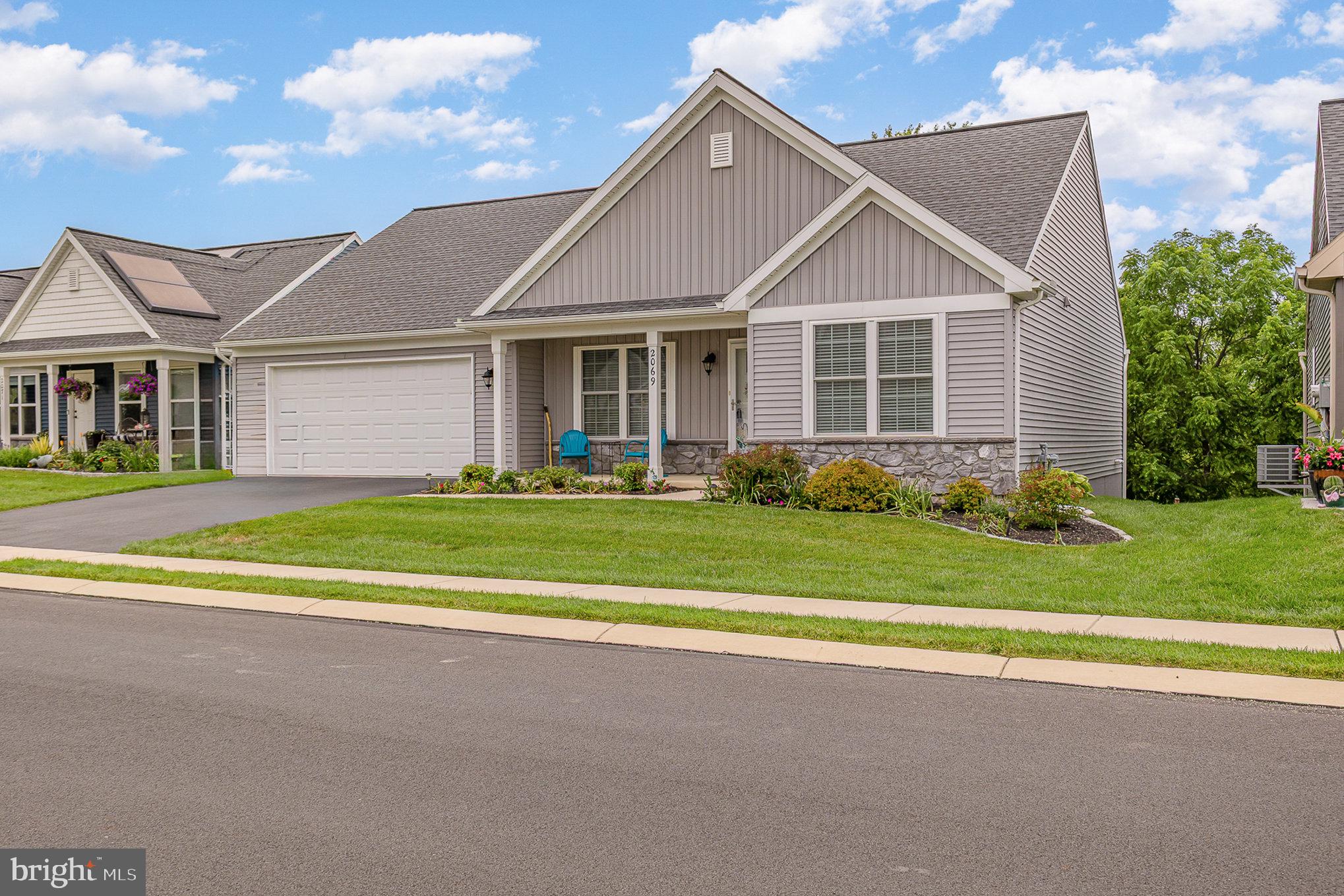 2069 Spring Wood Lane Mechanicsburg, PA 17055 - Photo 2 of 41 a front view of a house with a yard and trees