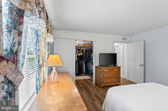 a bedroom with a bed and a television