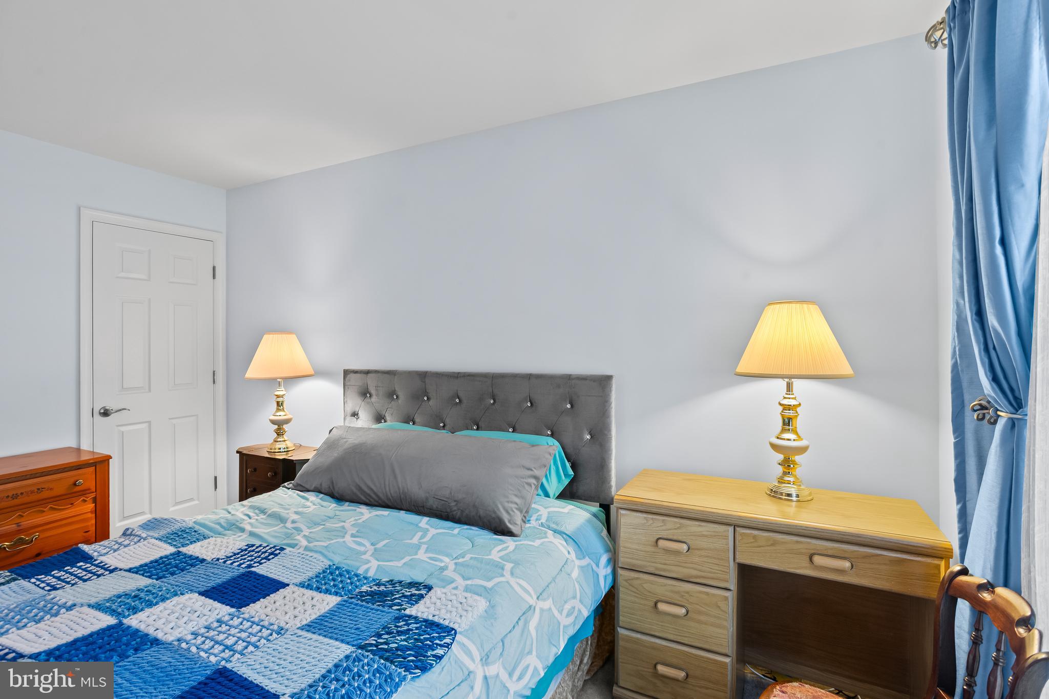 2069 Spring Wood Lane Mechanicsburg, PA 17055 - Photo 28 of 41 a bedroom with a bed and a lamp on dresser