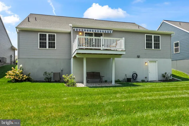 a view of a house with a yard and sitting area
