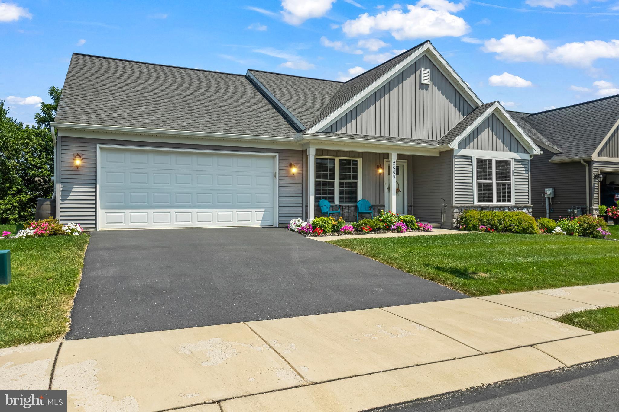 2069 Spring Wood Lane Mechanicsburg, PA 17055 - Photo 7 of 41 a front view of a house with a yard and potted plants