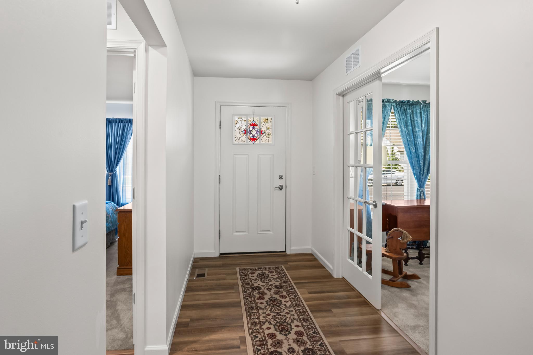 2069 Spring Wood Lane Mechanicsburg, PA 17055 - Photo 9 of 41 a view of hallway with wooden floor and a bathroom