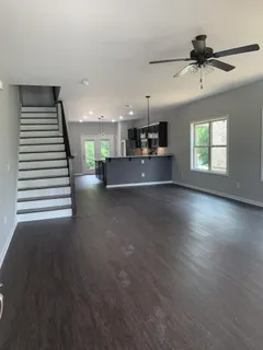 a view of a living room and kitchen with a large window