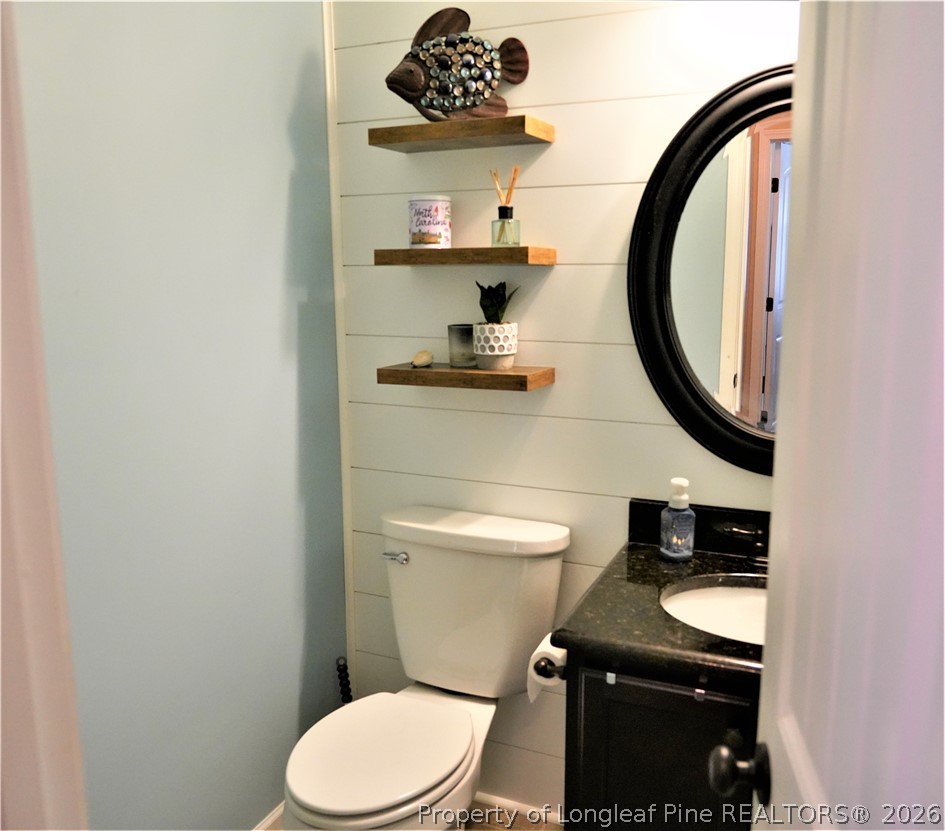 930 Old Vander Road Fayetteville, NC 28312 - Photo 22 of 45 a bathroom with a toilet a sink and a mirror