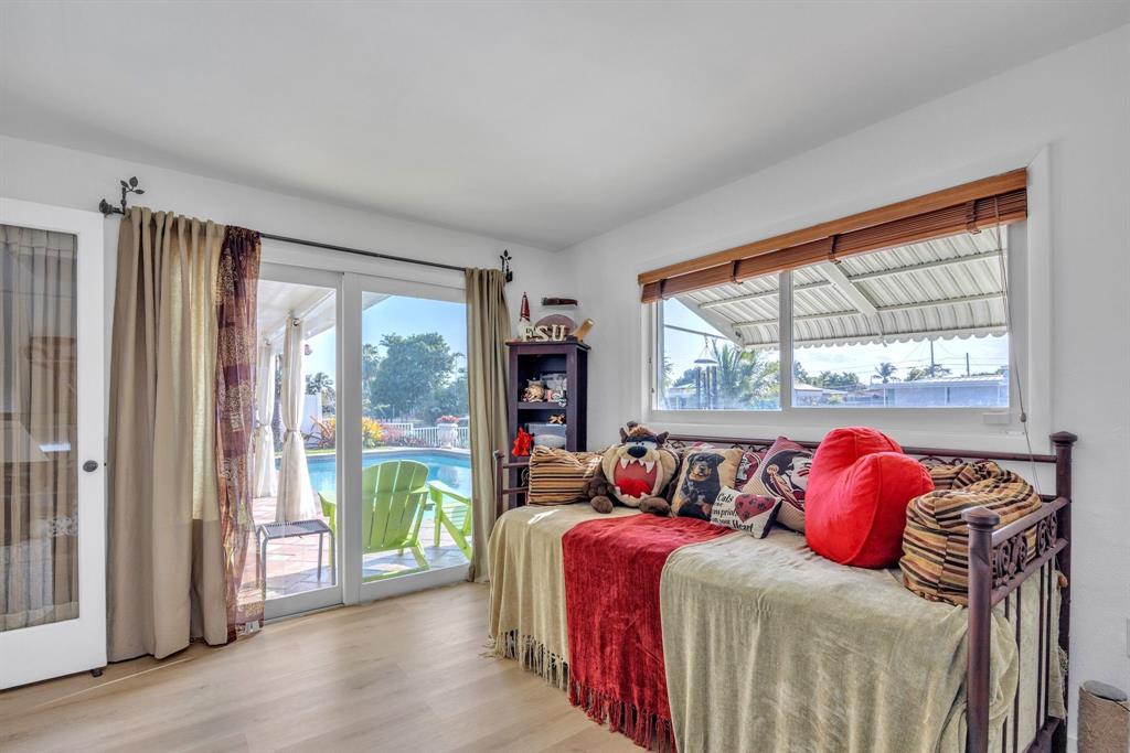 1611 Southwest 3rd Avenue Pompano Beach, FL 33060 - Photo 17 of 35 a bedroom with two beds and a large window