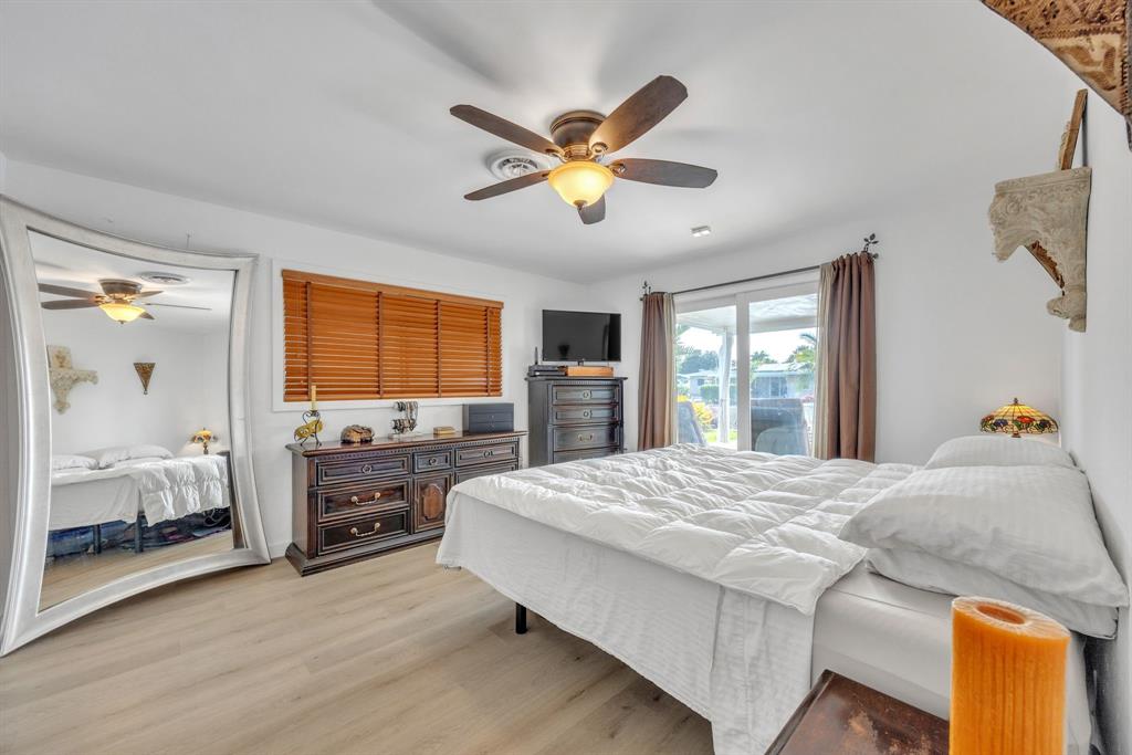 1611 Southwest 3rd Avenue Pompano Beach, FL 33060 - Photo 21 of 35 a bedroom with a bed and dresser with mirror