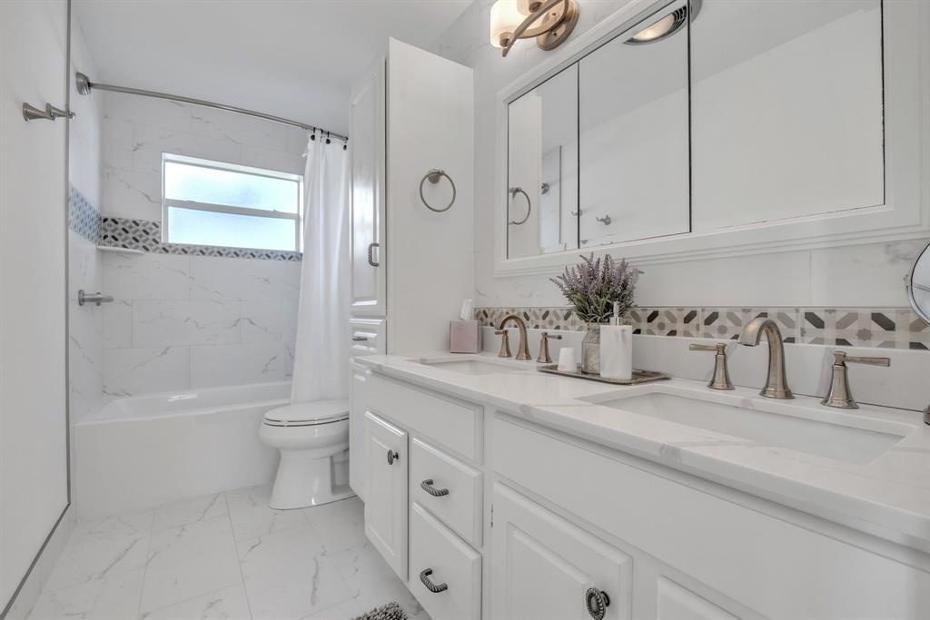 1611 Southwest 3rd Avenue Pompano Beach, FL 33060 - Photo 23 of 35 a bathroom with a granite countertop sink a toilet and bathtub