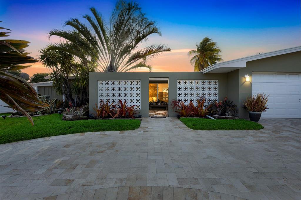 1611 Southwest 3rd Avenue Pompano Beach, FL 33060 - Photo 4 of 35 a front view of a house with a yard and a garage