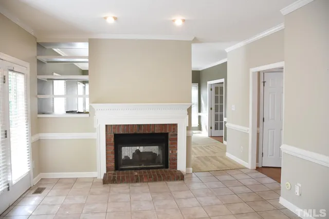 a view of a livingroom with a fireplace and window