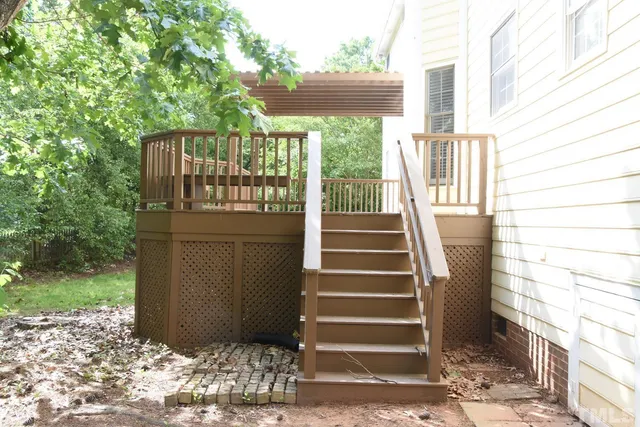 a view of a balcony with wooden floor and outdoor space