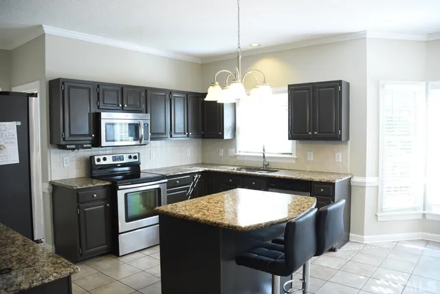 a kitchen with a sink stove and microwave